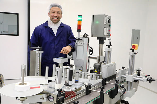 Michael Brubeck, CEO and founder of Centuria Foods in Dayton, stands at a labeling station