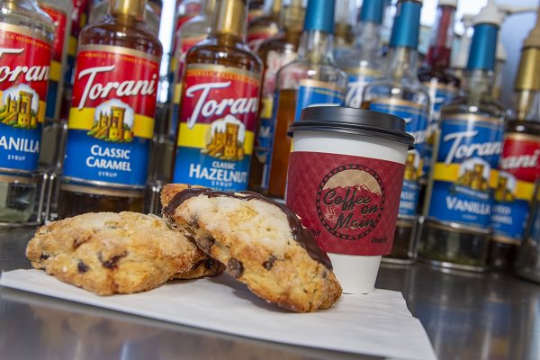 Baked goods in front on Torani syrups