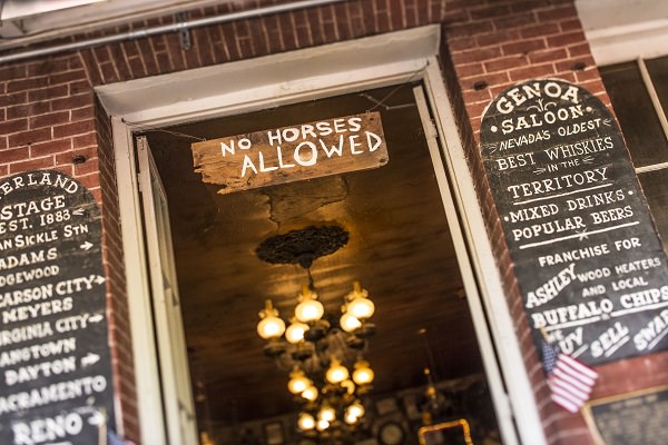 entrance to Genoa Bar with "No Horses Allowed" sign