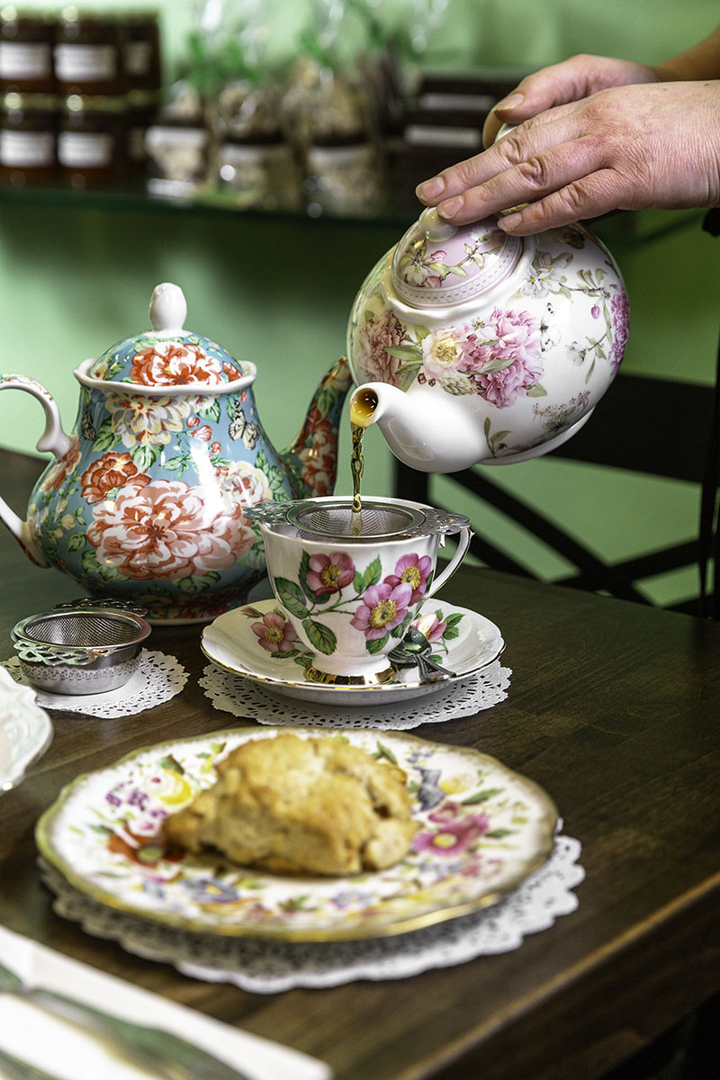 Bouchée Confections owner Natalie Landsinger pours tea at one of her shop's high tea events