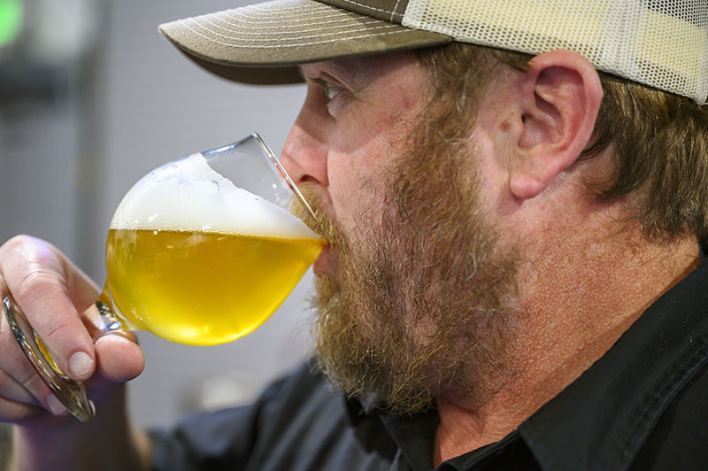 Matt Johnson of IMBĪB sips a beer at Schüssboom