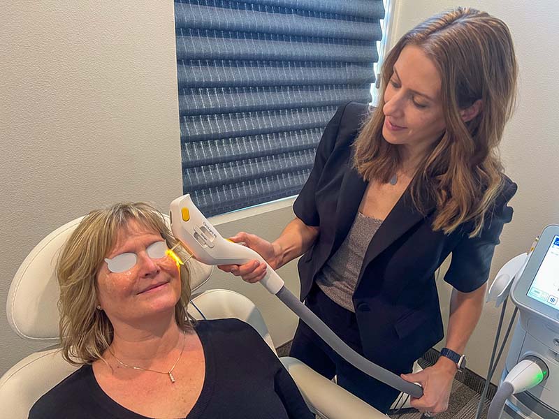 Dr. Jacqueline Donahue, co-owner and optometrist at NVision Optix, performs a pulsed light therapy treatment. Photo courtesy of NVision Optix